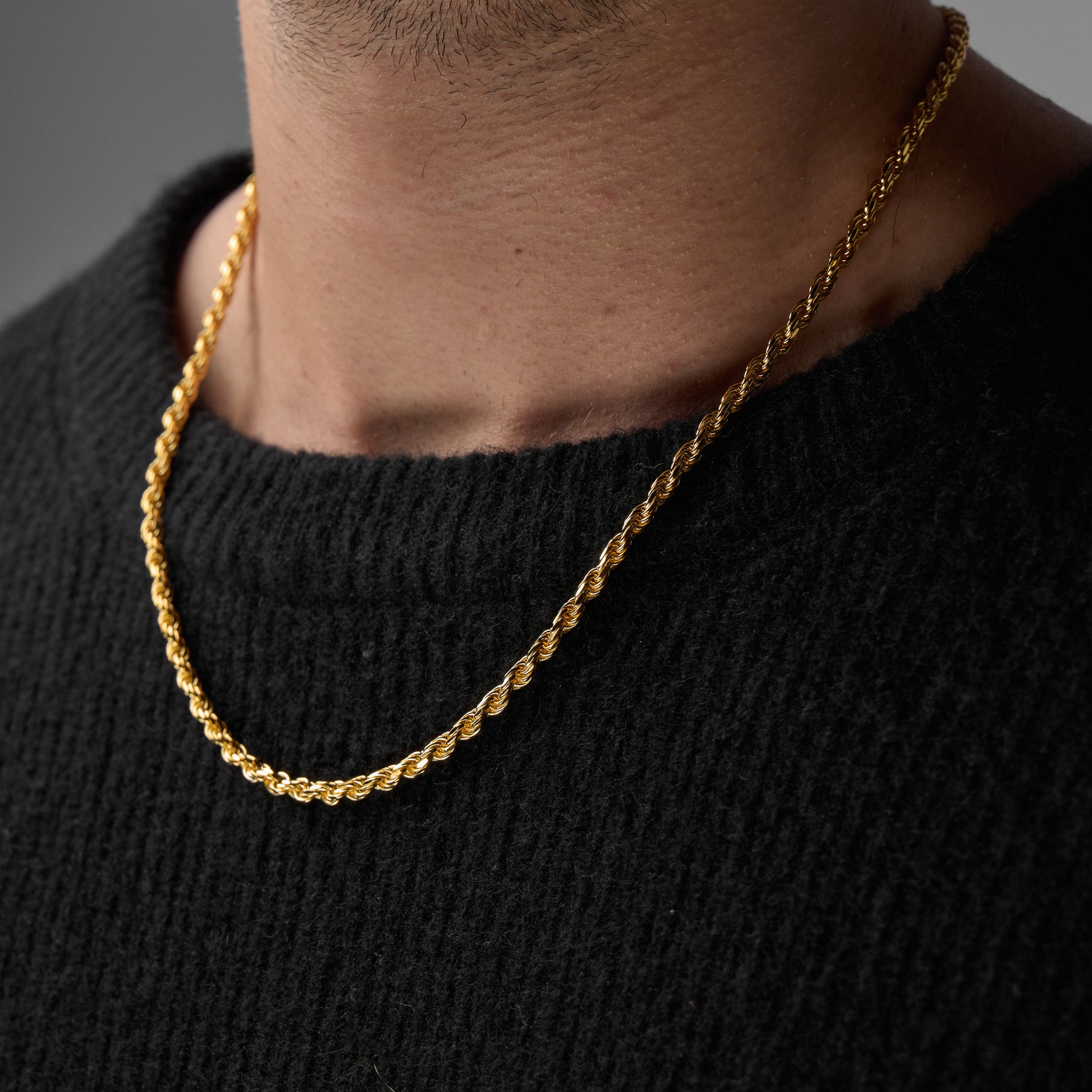 Close up shot man wearing gold Iris Necklace