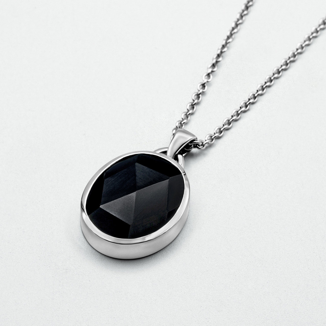 Suki Onyx Pendant featuring a rose-cut black onyx stone set in rhodium-plated recycled 925 sterling silver, hanging from a 52cm hammered sterling silver chain.