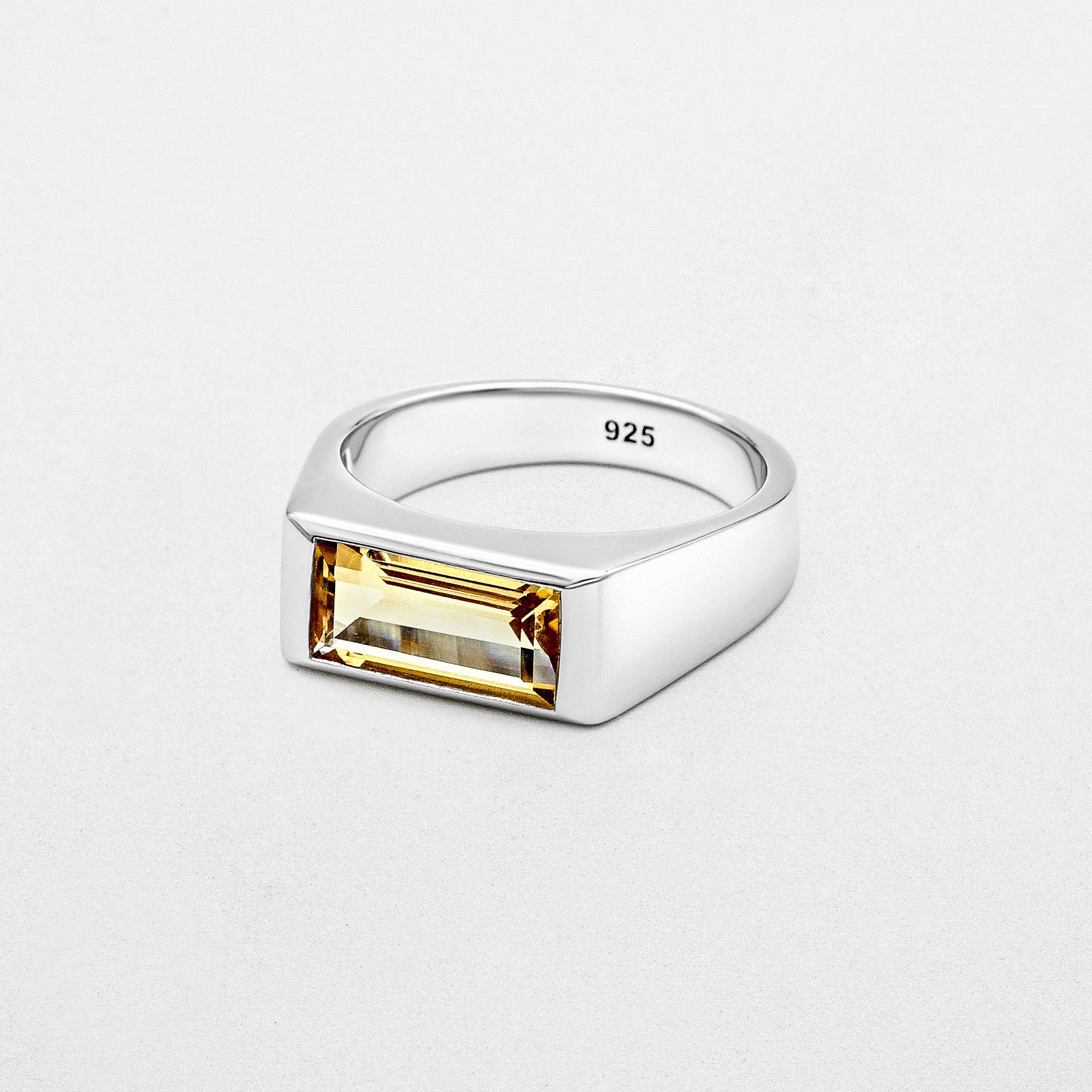 Citrine Signet Ring featuring a natural baguette-cut citrine stone set in high-polish rhodium-plated sterling silver on a blank canvas.