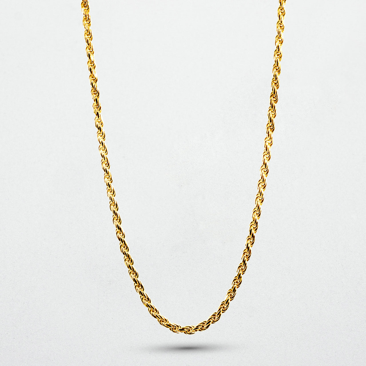 showcasing gold Iris Necklace on white canvas