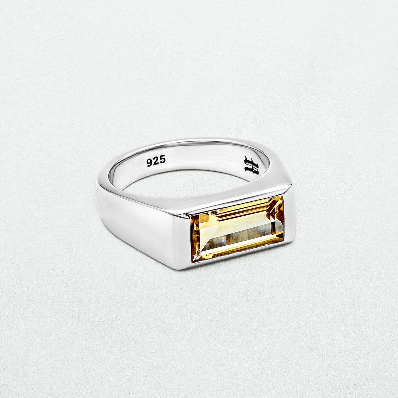 Citrine Signet Ring featuring a natural baguette-cut citrine stone set in high-polish rhodium-plated sterling silver on a blank canvas.