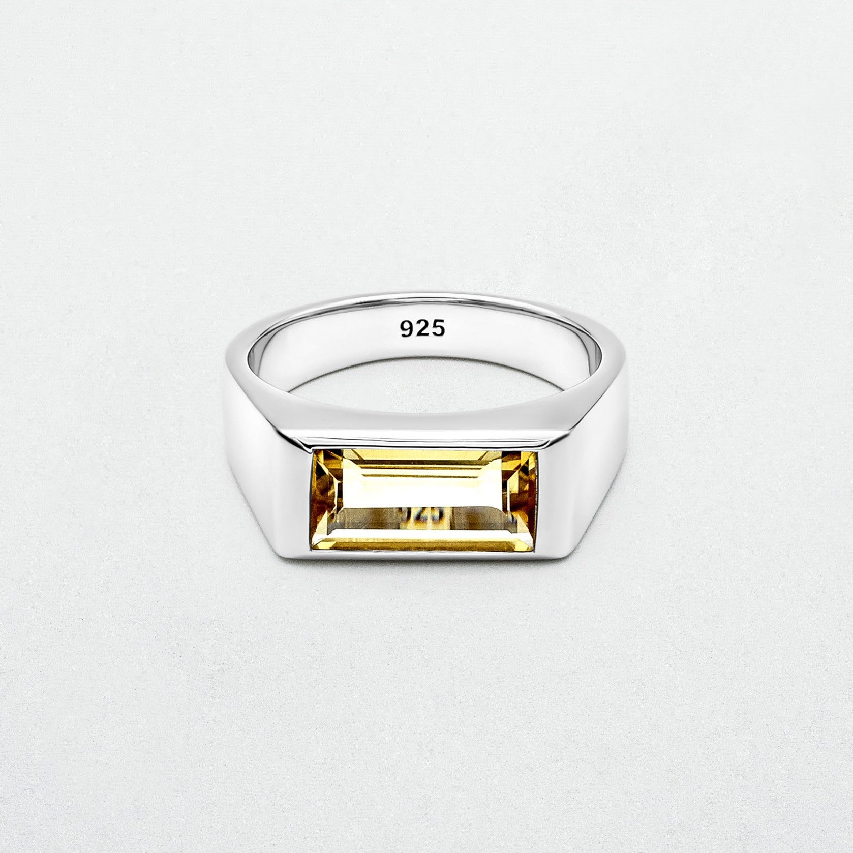  Citrine Signet Ring featuring a natural baguette-cut citrine stone set in high-polish rhodium-plated sterling silver on a blank canvas.