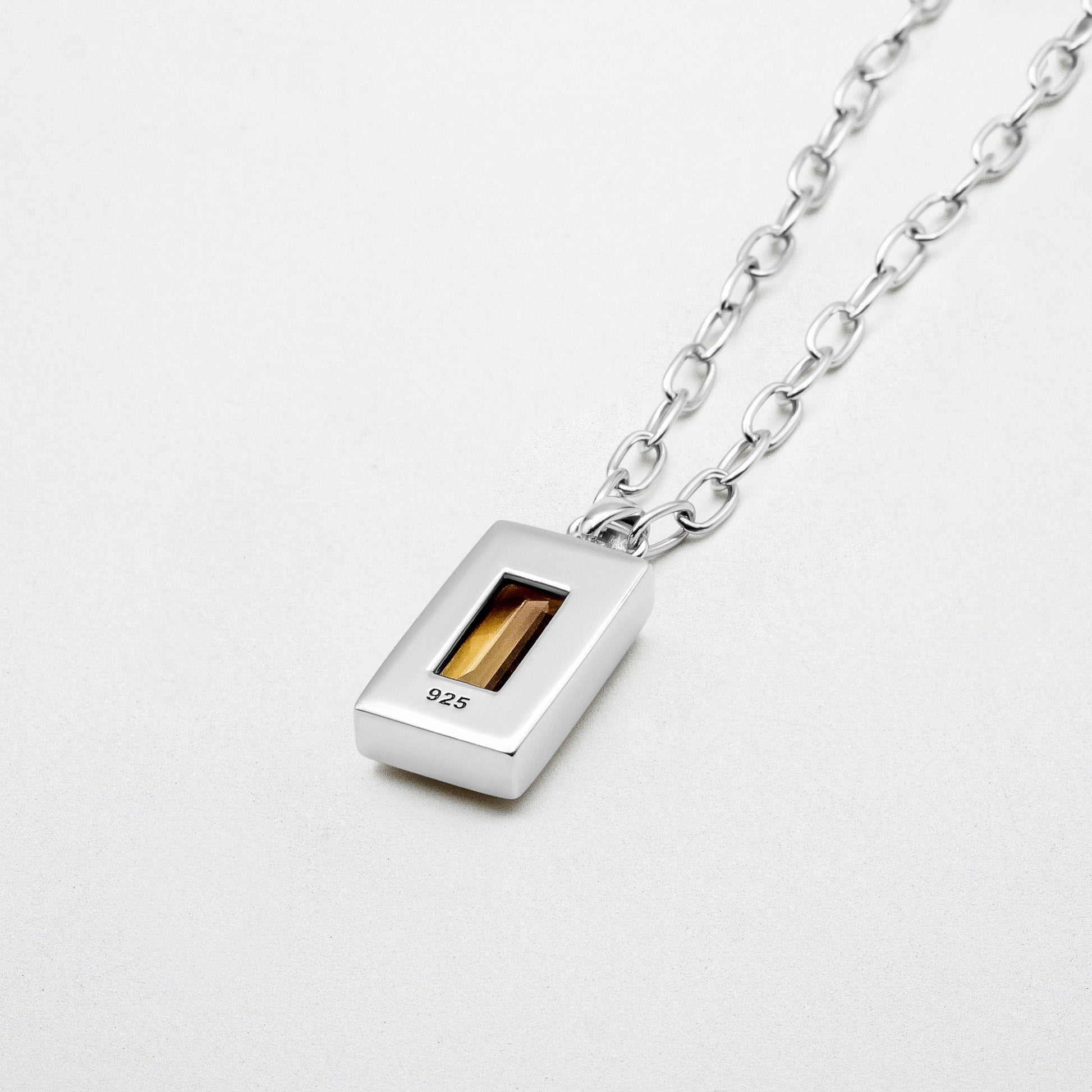 Citrine Pendant featuring a baguette-cut citrine stone set in rhodium-plated recycled sterling silver, hanging from a 55cm sterling silver chain.